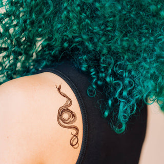 Serpent tattoo on shoulder blade